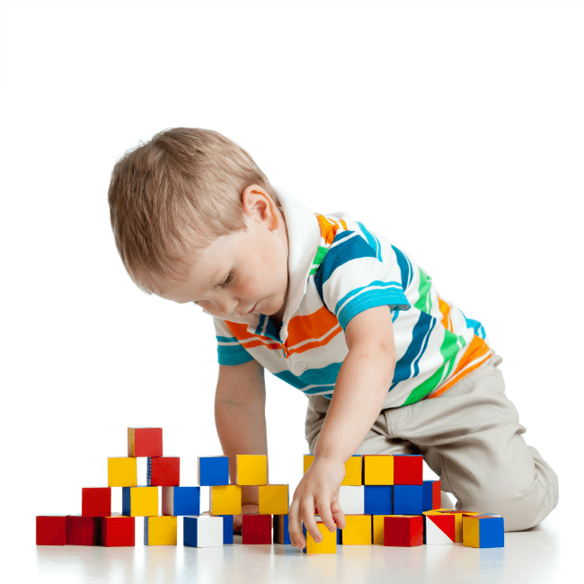 Child on the floor, building with blocks.