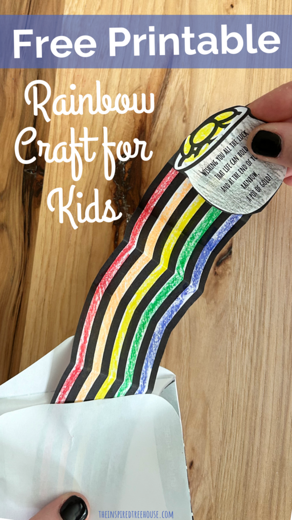 spring crafts for kids: Rainbow 3D card craft. Image of two hands holding the outstretched 3D rainbow card